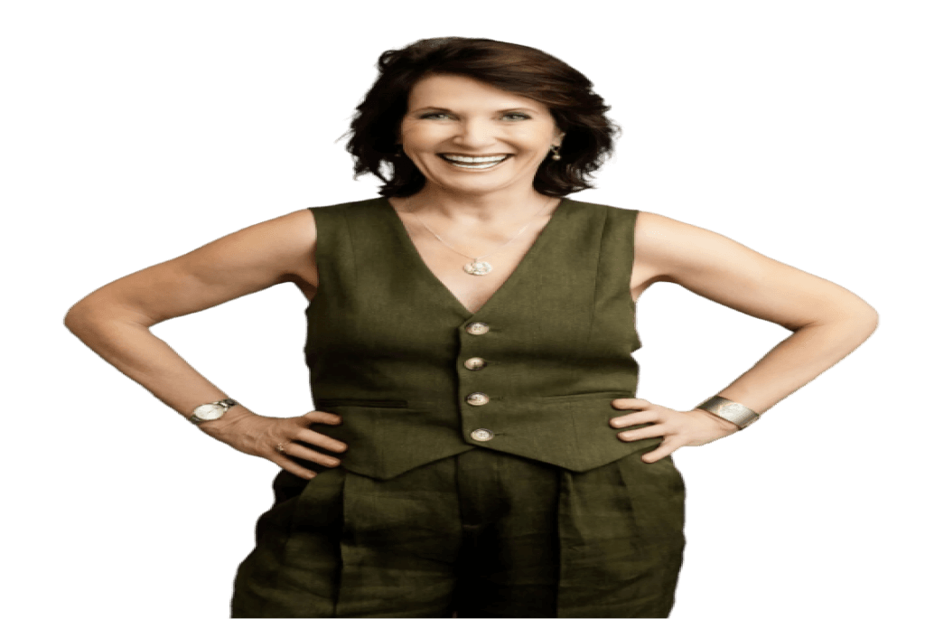 Dr. Margie Warrell laughing with both hands on her hips, in an olive linen waistcoat and matching wide-leg trousers