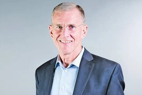 General Stanley McChrystal, US Army, retired — smiling, in a suit and open blue shirt
