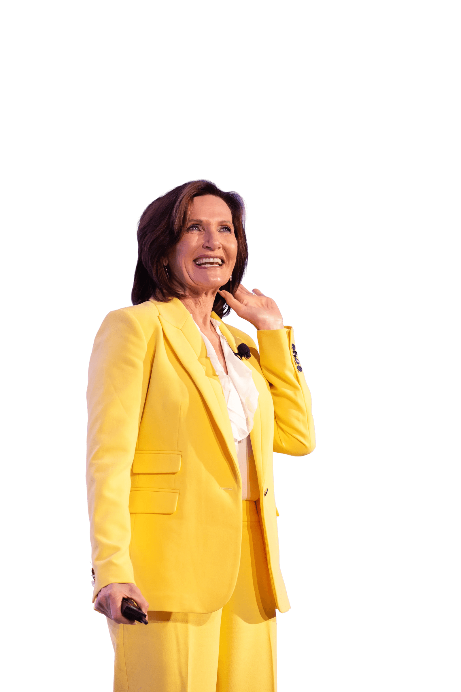 Margie Warrell in a bright yellow suit, laughing