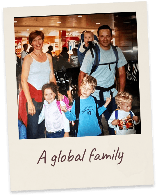 A global family. The family of six in an airport concourse loaded with backpacks and child carriers.