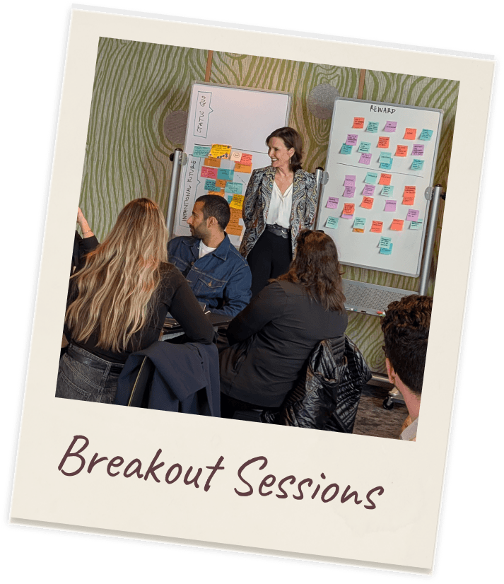 Polaroid captioned “Breakout Sessions”: a breakout workshop with participants seated round a table in the foreground and a facilitator presenting at two flip-chart sheets covered in coloured sticky notes